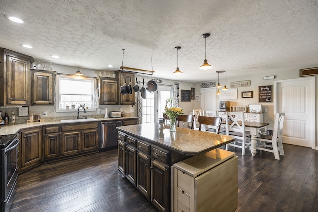 kitchen with dark wood-type flooring, dishwasher, a kitchen island, range with electric cooktop, and sink