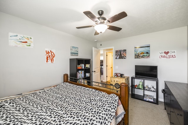 carpeted bedroom featuring a textured ceiling and ceiling fan