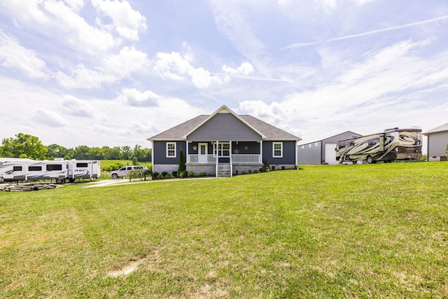 back of property with a porch and a lawn