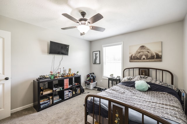 bedroom with carpet flooring, a textured ceiling, and ceiling fan