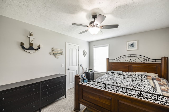 bedroom featuring light carpet, a closet, a textured ceiling, and ceiling fan