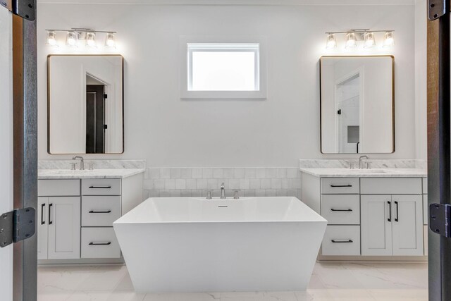 bathroom featuring vanity, tile walls, and a tub