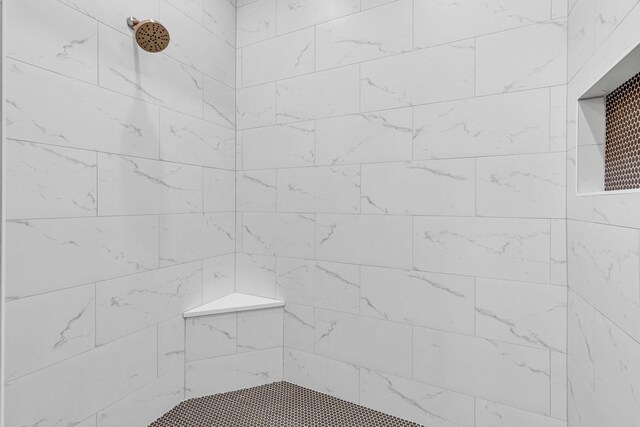 bathroom with tiled shower