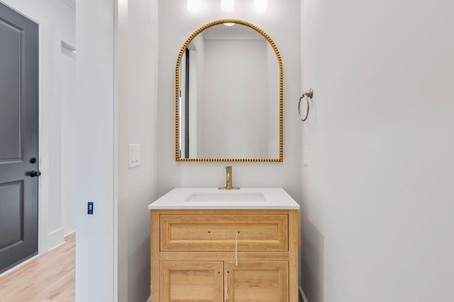 bathroom featuring hardwood / wood-style flooring and vanity