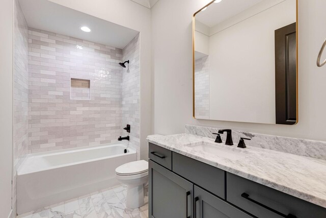 full bathroom featuring vanity, toilet, and tiled shower / bath combo