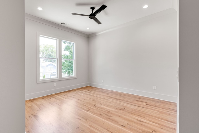 spare room with crown molding, light hardwood / wood-style flooring, and ceiling fan