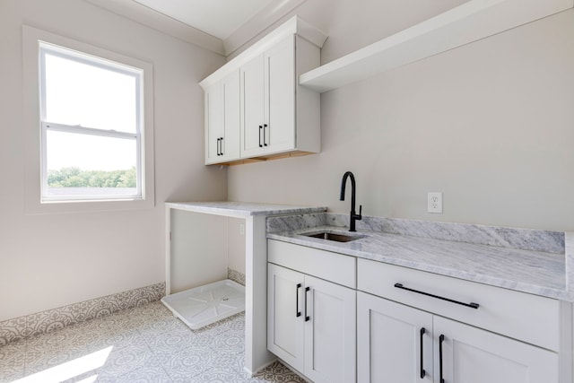 laundry room with light tile patterned flooring and sink