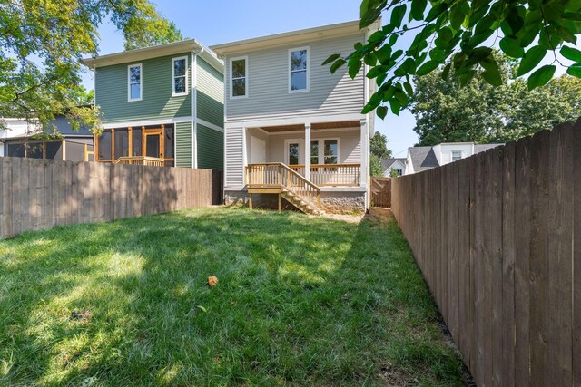 rear view of house with a lawn