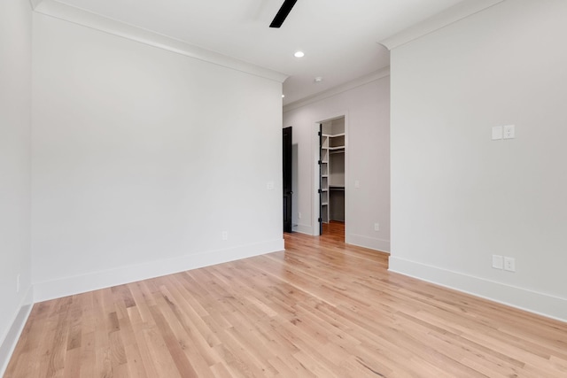 unfurnished room featuring ceiling fan, ornamental molding, and light hardwood / wood-style flooring