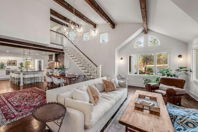 living room with hardwood / wood-style floors, high vaulted ceiling, beamed ceiling, and a notable chandelier