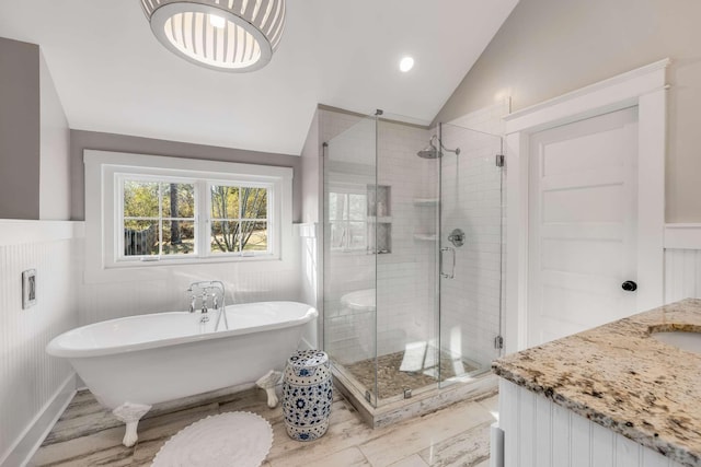 bathroom with separate shower and tub, lofted ceiling, and vanity