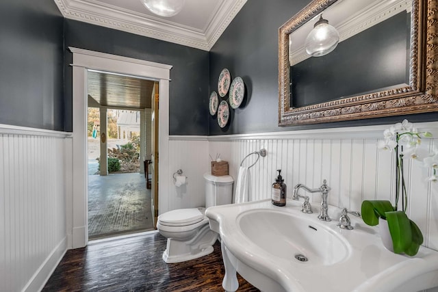 bathroom with ornamental molding, toilet, sink, and hardwood / wood-style floors