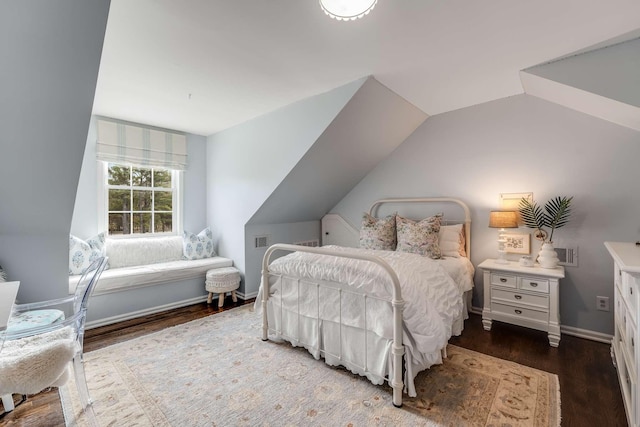 bedroom with vaulted ceiling and dark hardwood / wood-style flooring