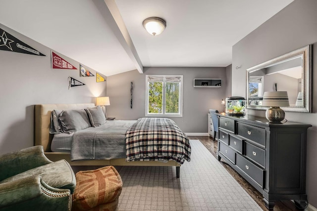 bedroom featuring lofted ceiling with beams