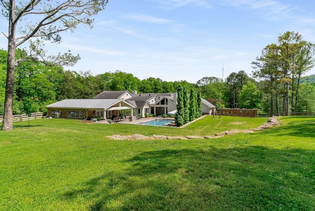 rear view of house featuring a patio area and a lawn