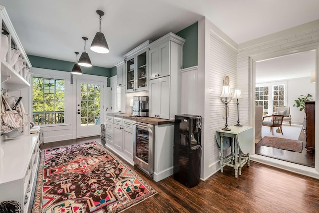 kitchen featuring dark wood-type flooring, beverage cooler, and decorative light fixtures