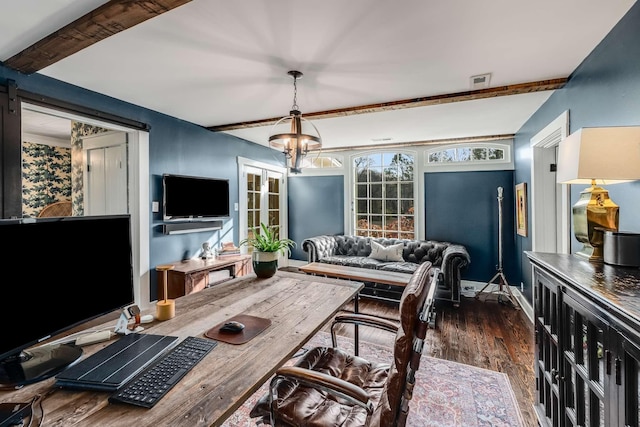 interior space featuring dark wood-type flooring, beamed ceiling, a barn door, and a notable chandelier