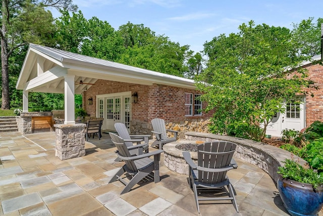 view of patio featuring french doors and a fire pit