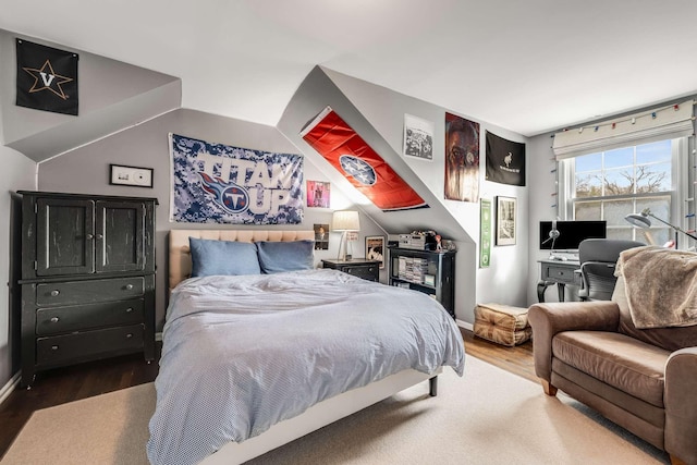 bedroom featuring hardwood / wood-style floors and lofted ceiling