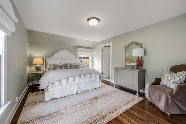 bedroom featuring dark hardwood / wood-style floors and lofted ceiling