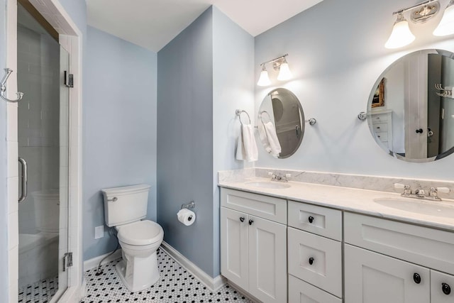 bathroom with toilet, vanity, tile patterned flooring, and a shower with shower door