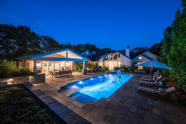 view of pool featuring a patio area and an outbuilding