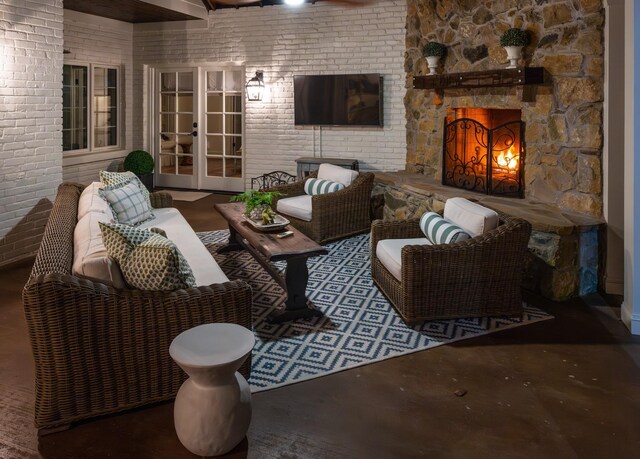 interior space featuring french doors and an outdoor living space with a fireplace