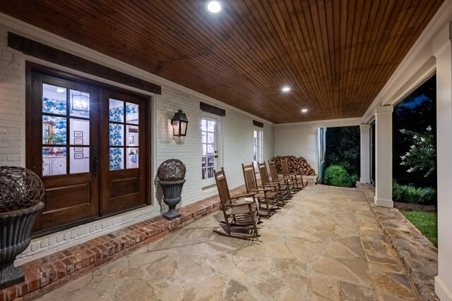 exterior space featuring covered porch and french doors