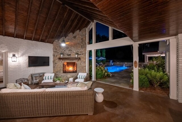 view of patio with an outdoor living space with a fireplace