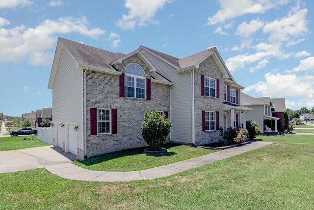 colonial-style house featuring a garage and a front lawn