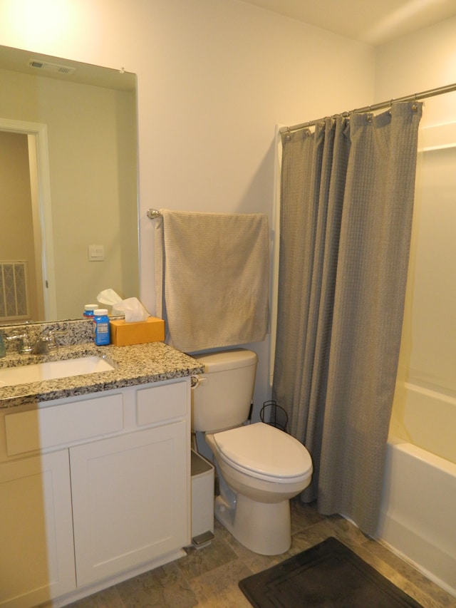 full bathroom featuring vanity, shower / tub combo, and toilet