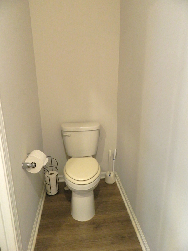 bathroom featuring wood-type flooring and toilet