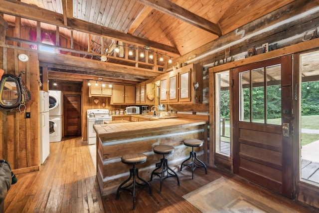 kitchen with lofted ceiling with beams, white range oven, light hardwood / wood-style floors, wooden walls, and wood ceiling