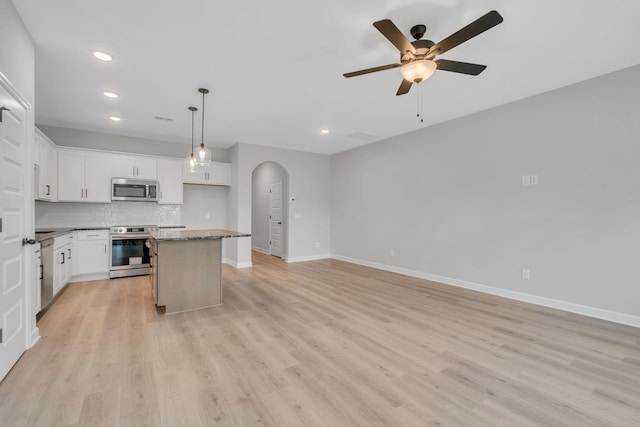 kitchen featuring white cabinetry, appliances with stainless steel finishes, and a center island