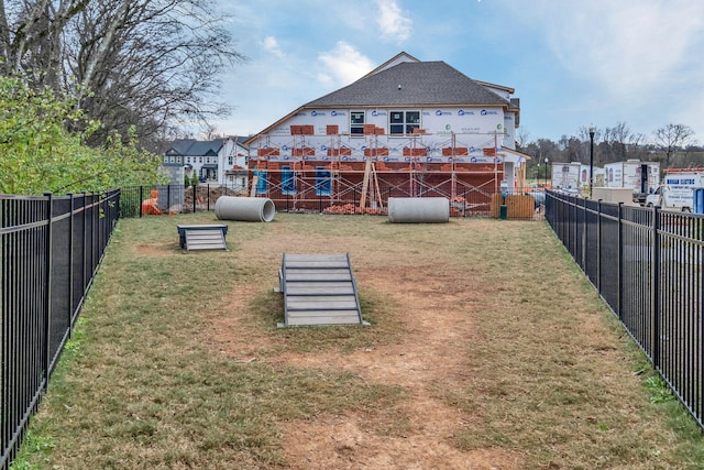 rear view of house featuring a lawn