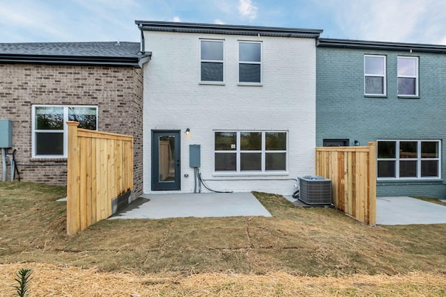 back of house featuring a patio, central AC unit, and a lawn