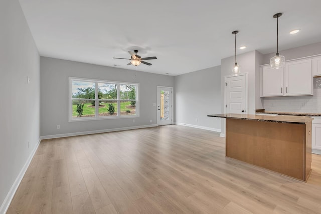 kitchen featuring ceiling fan and light hardwood / wood-style flooring