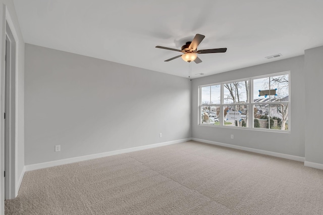 carpeted spare room featuring ceiling fan