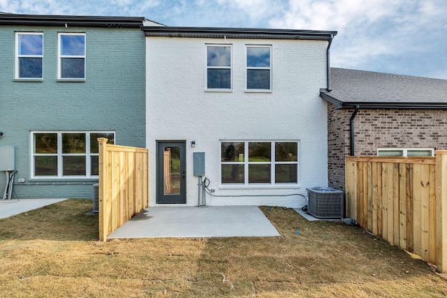 back of property featuring a patio area, a yard, and cooling unit