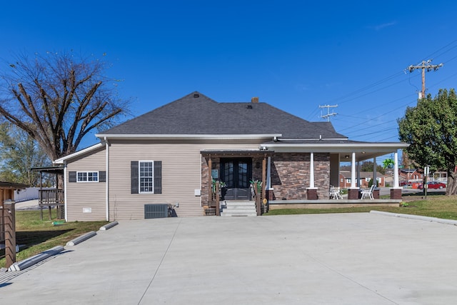 rear view of property with covered porch