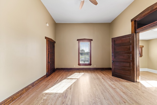 empty room with ceiling fan and light wood-type flooring