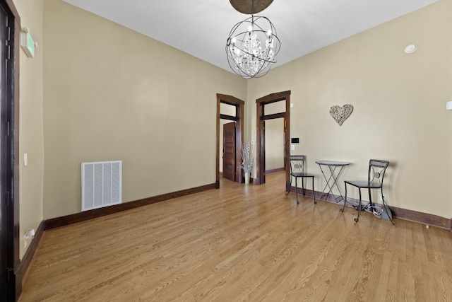 interior space with a notable chandelier and light hardwood / wood-style floors