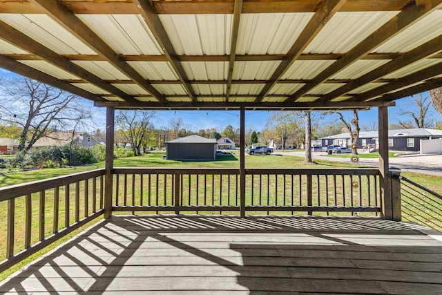 wooden terrace with a lawn