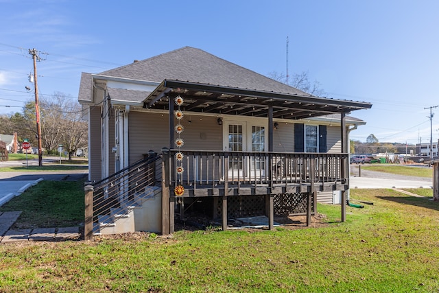 back of house featuring a wooden deck and a lawn