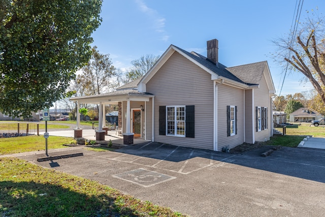 rear view of house with covered porch