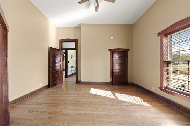 unfurnished room with light hardwood / wood-style flooring and ceiling fan