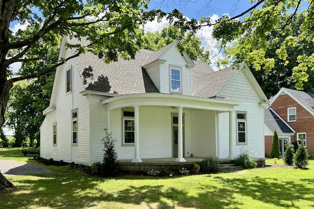 view of front of property with covered porch and a front lawn