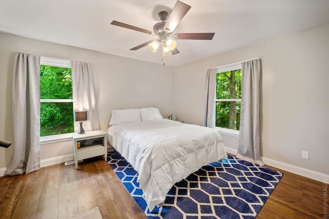 bedroom featuring ceiling fan and dark wood-type flooring