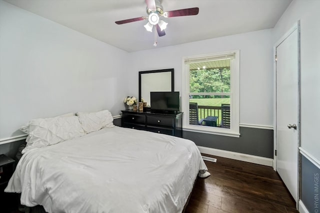 bedroom with ceiling fan and dark hardwood / wood-style flooring