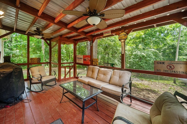 sunroom / solarium featuring ceiling fan